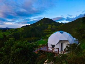 a dome tent sitting on top of a hill at Golden Glamping & Suites in Guatavita