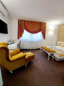 a hotel room with two beds and a window at Hotel u Liska in Kutno