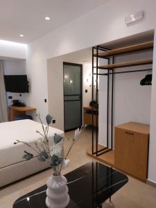 a bedroom with a bed and a vase with flowers on a table at Anastasia Apartments in Bali