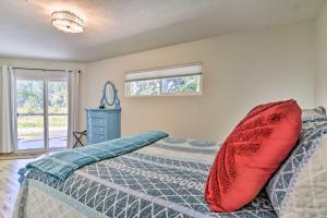 ein Schlafzimmer mit einem Bett mit einem roten Kissen darauf in der Unterkunft Waterfront Troutdale Hideaway Sandy River Fishing in Troutdale