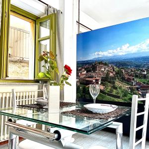a dining room with a glass table and a view at 10mt dal Duomo Ca del Duomo in Alba