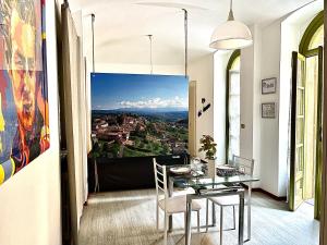 a dining room with a table and a view at 10mt dal Duomo Ca del Duomo in Alba