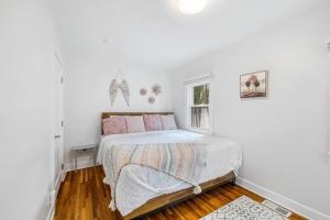 a white bedroom with a bed and a window at Gorgeous Downtown Bungalow in Coeur d'Alene