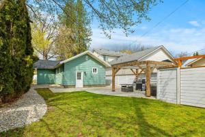 a home with a green house and a white garage at Gorgeous Downtown Bungalow in Coeur d'Alene