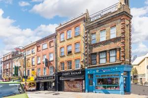 a building on the corner of a street at Verv Brick Lane in London