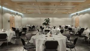a room filled with tables and chairs with white table cloth at Radisson Blu Hotel, Lucerne in Lucerne