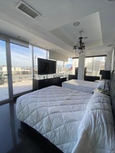 Giường trong phòng chung tại Departamento Penthouse en Salta Capital +56 ảnh