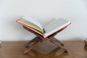 an open book sitting on top of a wooden stand at Hemingway House - Pool-Hot Tub-Hammocks and Fire pit in Yucca Valley