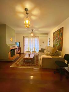 a living room with a couch and a table at Apartamento Alto da Serra - 024 in Gramado