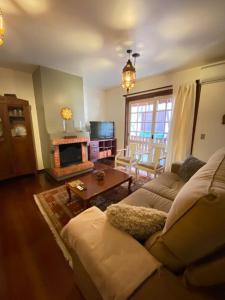 a living room with a couch and a fireplace at Apartamento Alto da Serra - 024 in Gramado