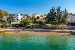 a group of people on a beach in the water at Apartments with parking space Vantacici, Krk - 5566 in Malinska