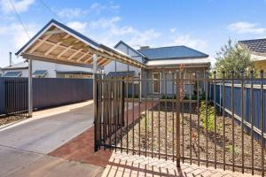 a gate in front of a house with a fence at 4-Bedroome home, new bathrooms and close to town in Kalgoorlie
