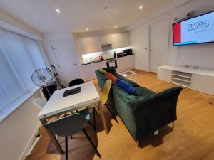 a living room with a couch and a table at City Centre Stylish Apartment Croydon-Free Parking Provided in Croydon