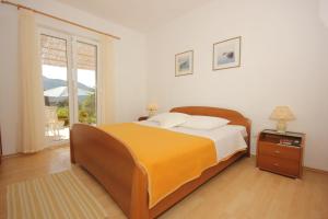 a bedroom with a bed and a window at Apartments and rooms by the sea Srebreno, Dubrovnik - 8957 in Mlini