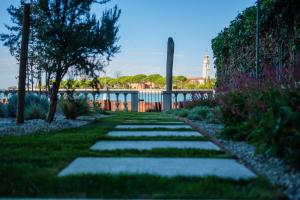 A garden outside Ca' delle Contesse - Villa on lagoon with private dock and spectacular view