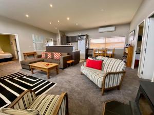 a living room with two couches and a table at All Year Getaway in Twizel
