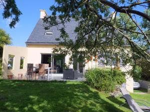 une maison blanche avec une cour dans l'établissement Cottage, Guisseny, à Guissény