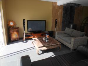 a living room with a couch and a coffee table at Holiday Home in France near Sandy Beaches in Guissény