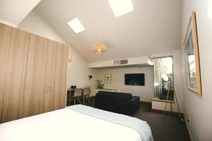 a living room with a large bed and a large window at Salamanca Inn in Hobart