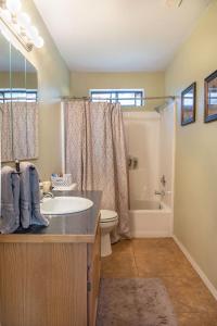 a bathroom with a sink and a toilet and a tub at Grand Canyon 1bd Loft at Historic Wrigley Ranch-Suite with Horseback Riding, Hiking in Parks +26 photos