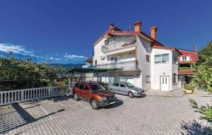 two cars parked in front of a house at Apartments with a parking space Kastav, Opatija - 15287 in Kastav