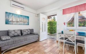 a living room with a couch and a table at Apartments with a parking space Kastav, Opatija - 15287 in Kastav
