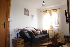 un salon avec un canapé et une fenêtre dans l'établissement Family friendly house with a swimming pool Skrip, Brac - 15297, à Supetar