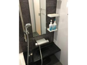 a bathroom with a shower with a sink and a mirror at Minshuku Kakutani Hitohira - Vacation STAY 16023v in Wada