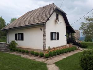 a white house with a black roof at Holiday house with a parking space Poljanak, Plitvice - 15340 in Poljanak