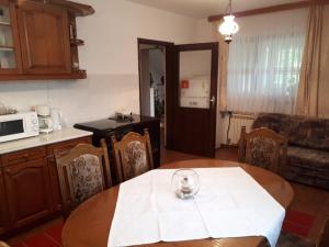 a kitchen with a table with a wine glass on it at Holiday house with a parking space Poljanak, Plitvice - 15340 in Poljanak