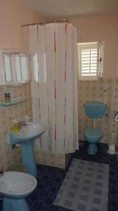 a bathroom with two sinks and a toilet and a shower at Apartments and rooms with parking space Hvar - 15378 in Hvar