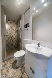a bathroom with a sink and a toilet and a shower at Holiday house with WiFi Novi Vinodolski - 15397 in Novi Vinodolski +19 photos