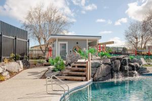 a small house with a swimming pool in a yard at Taupo TOP 10 Holiday Park in Taupo