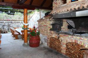a brick oven in a patio with a table at Apartments with WiFi Zlarin - 15409 in Zlarin