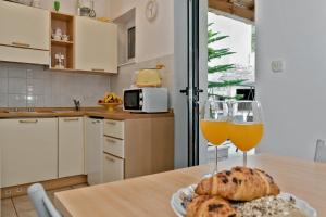 a kitchen with a table with two glasses of wine at Apartments and rooms with parking space Bol, Brac - 15418 in Bol