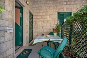a table and chairs sitting on a patio at Apartments and rooms with parking space Bol, Brac - 15418 in Bol +29 photos