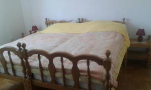 a bed in a bedroom with two lamps on tables at Apartments by the sea Cres - 15426 in Cres