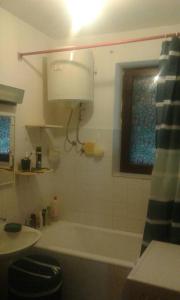 a bathroom with a tub and a sink and a window at Apartments by the sea Cres - 15426 in Cres
