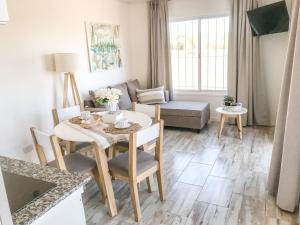 a living room with a table and a couch at Cabañas Titina's Lake in Potrero de Garay