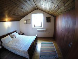 a bedroom with a bed with a wooden ceiling at Holiday house with a parking space Lozisca, Brac - 15444 in Ložišće