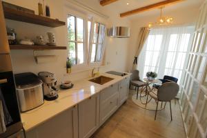 a kitchen with a sink and a table with chairs at Apartments with a parking space Hvar - 15460 in Hvar