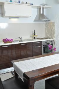a kitchen with a sink and a stove top oven at Apartments with a parking space Barbat, Rab - 15459 in Rab