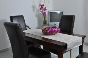 a dining room table with a bowl of flowers on it at Apartments with a parking space Barbat, Rab - 15459 in Rab