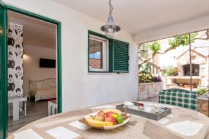 a bowl of fruit on a table in a room at Apartments with WiFi Stari Grad, Hvar - 15464 in Stari Grad