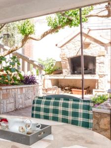 a patio with a table and a stone fireplace at Apartments with WiFi Stari Grad, Hvar - 15464 in Stari Grad