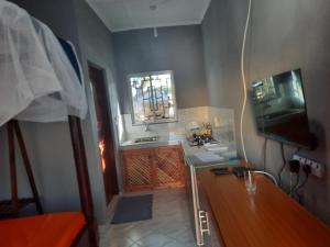 a small kitchen with a sink and a window at Casa Da Luna Studios in Watamu