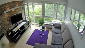 a living room with a couch and a tv at Apartments with WiFi Zagreb - 15474 in Zagreb