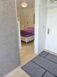 a room with a bed and a room with a door at Apartments with WiFi Zagreb - 15474 in Zagreb