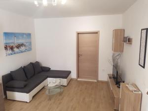 a living room with a couch and a table at Apartments with a parking space Maslenica, Novigrad - 15482 in Jasenice