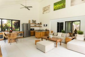 a living room with a table and a kitchen at Villa Shamballa - Bingin - 2 Bedrooms in Uluwatu